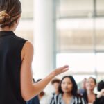 A young woman participates in a Toastmasters speech contest.