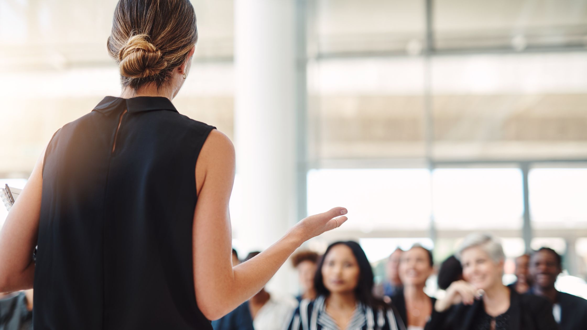 A young woman participates in a Toastmasters speech contest.