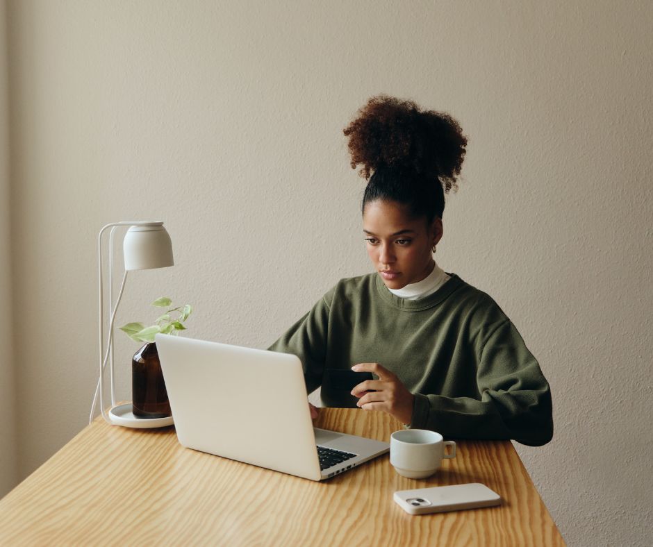 A young woman sits at her desk and views online training.